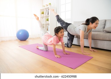 Asian Pretty Mother And Her Youth Kid Daughter In The Gym Center Doing Stretching Fitness Exercise Yoga Together, Parent Accompany Children Sport Concept.