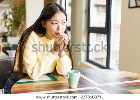asian pretty woman with a coffee cup at cool home