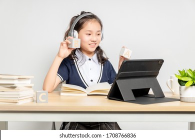 Asian Primary School Girls Who Are Taking English Online Courses