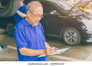 Asian Professional Adult Garage Owner Working Checking Customer Car