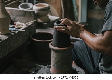 Asian Professional Artisan Potter Making Art Pot Or Vase Handicraft On Wheel In Pottery Workshop Studio.