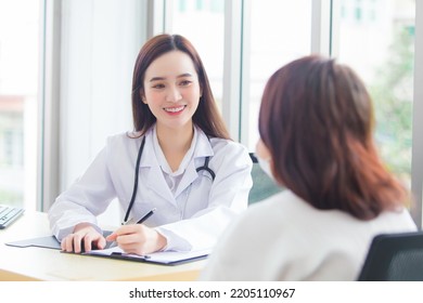 Asian professional doctor woman who wears medical coat talks with female patient to suggest treatment guideline and healthcare concept in office of hospital. - Powered by Shutterstock