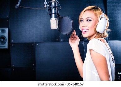 Asian Professional Musician Recording New Song Or Album CD In Studio