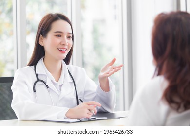 Asian professional  woman doctor suggests healthcare solution to her patient elderly in examination room at hospital.