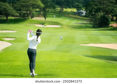 Asian professional woman golfer play a golf game on tee off in green grass golf course with Fuji mt, sport, travel and relax in vacation time in Tokyo, Japan - Powered by Shutterstock