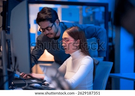 Asian programmers collaborating on software development at night, focused on writing code across multiple monitors in a tech office environment  Programmers Collaborating on Software Development 