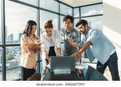 Asian project manager uses laptop displayed data analysis while professional business team brainstorming marketing idea at business meeting. Working together,sharing idea, planing strategy. Tracery. - Powered by Shutterstock