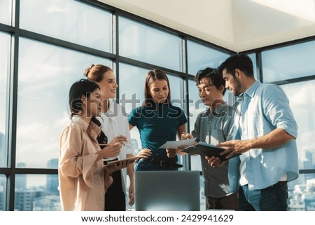 Asian project manager uses laptop displayed data analysis while professional business team brainstorming marketing idea at business meeting. Working together,sharing idea, planing strategy. Tracery.