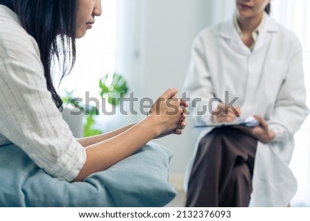 Asian psychology doctor examine and listen to woman patient at home. Attractive beautiful female physician give advise and consult to help young girl solve problem for Psychologic health care in house