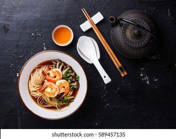 Asian Ramen Noodles With Broth In Bowl Serving Size And Tea On Dark Background