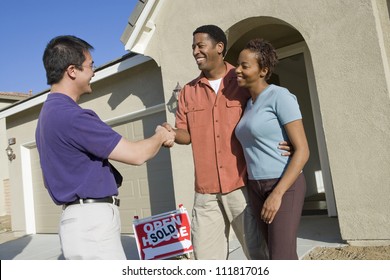 Asian Real Estate Agent With Couple Buying New House