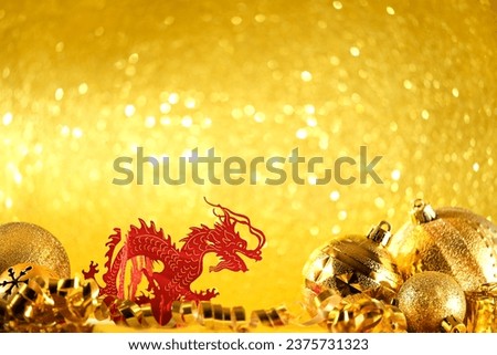 asian red dragon and festive shiny christmas decorations close up on light golden abstract glittering background. lunar new year 2024 symbol. element for design. copy space