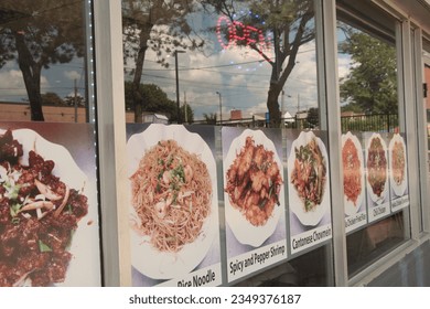 asian restaurant windows with neon open sign and pictures of meals dishes with caption writing beneath cantonese chowmein chicken fried rice chili chicken, entrance door, reflection sky trees - Powered by Shutterstock