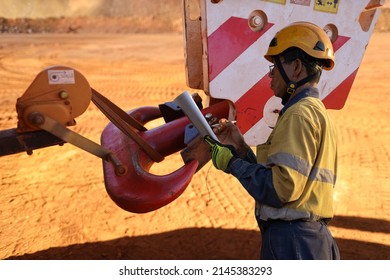 Asian Rigger High Risk Worker Wearing Helmet Glove Inspector Conducting Inspecting Checking Crane Lifting Hook Prior Lifting Construction Building Site, Australia 
