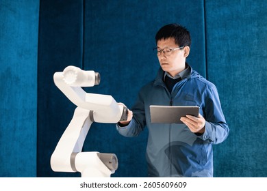 asian Robotics Engineer Researching and Developing a Technological Robot Arm Project