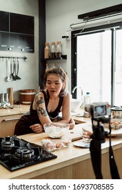 Asian Rocker Woman Making Bread In The Kitchen Infront Of Camera.