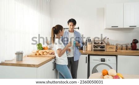 Asian romantic couple wife and husband drinking a cup of coffee and hot chocolate with bakery near morning corner in the cooking kitchen at house