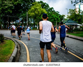 Asian Runner Group Jogging In The City Central Park,running Concept