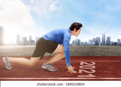 Asian Runner Man Ready To Run On The 2021 Line. Happy New Year 2021