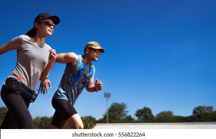 Asian Runner are rehearsing jogging, running on the pitch. - Powered by Shutterstock