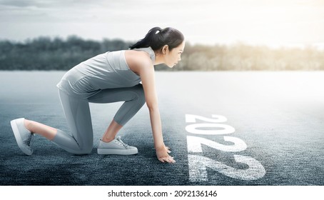 Asian Runner Woman Ready To Run On The 2022 Line. Happy New Year 2022