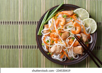 Asian Salad With Rice Noodles With Chicken, Shrimp And Vegetables Closeup. Horizontal View From Above 