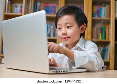 Asian School Boy In White Shirt Pointing On Computer Screen