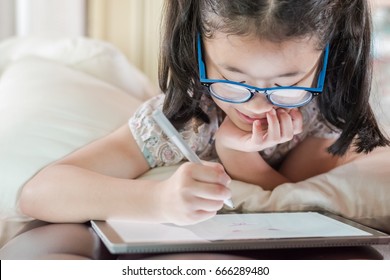 Asian School Child Girl Using Smart Tablet Drawing On Innovative Touchscreen Surface Digital Technology Device