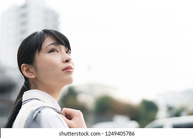 Asian School Girl Looking Up To The Sky.