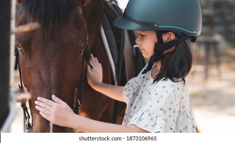 Asian school kid girl with horse ,riding or practicing horse ridding at horse ranch. - Powered by Shutterstock
