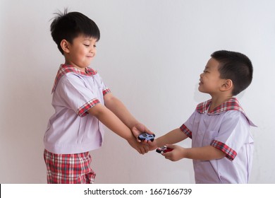 Asian schoolchildren share toys for good friendship.