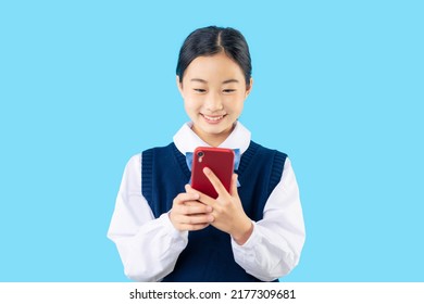 Asian schoolgirl using a smart phone with school uniform. - Powered by Shutterstock