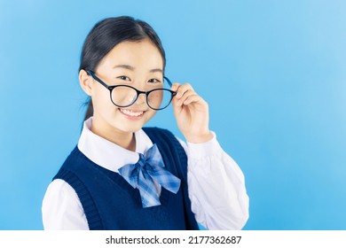 Asian Schoolgirl Wearing Eye Glasses With School Uniform.