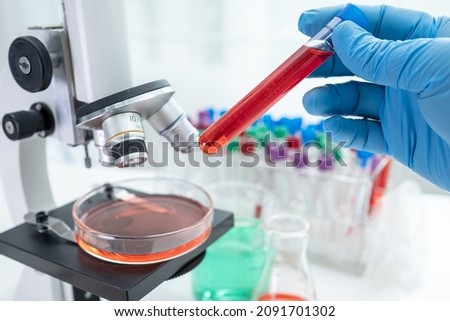 Asian scientist biochemist or microbiologist working research with a microscope in laboratory. For protect outbreak Coronavirus Covid19, bacteria and germs. ストックフォト © 