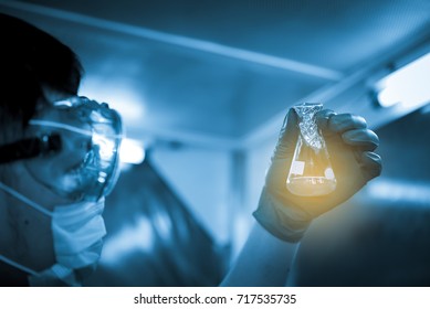 Asian Scientist looking tube in hand,working in lap,experiment with chemical,thailand people