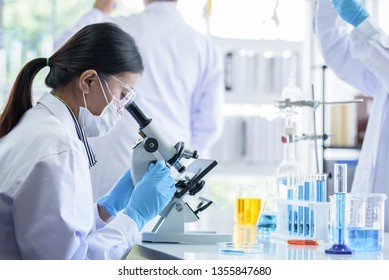 Asian scientist team has researching in laboratory.
