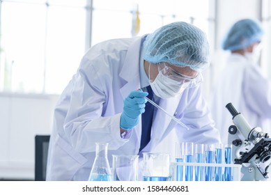 Asian scientist team has researching in laboratory. - Shutterstock ID 1584460681