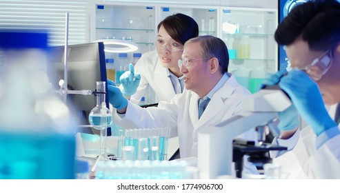 asian scientist team meeting and writing analysis results in the laboratory