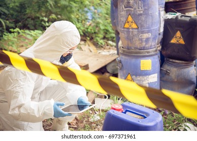 Asian scientist wear Chemical protection suit check danger chemical,working at dangerous zone