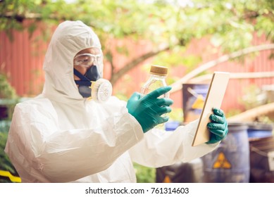 Asian scientist wear Chemical protection suit check danger chemical,working at dangerous zone,authenticating the dangerous chemicals
