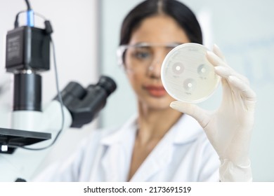 Asian scientist woman are and showing the results of drug resistant in the laboratory room.