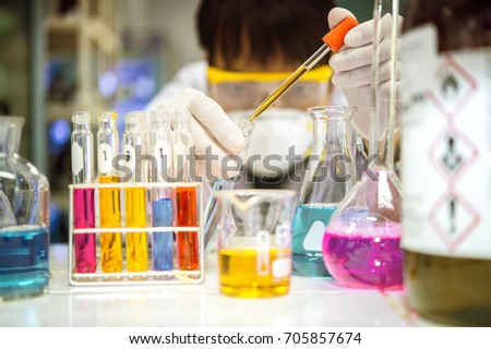 Asian scientists are experimenting with chemistry in the laboratory.