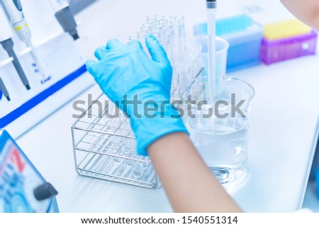 The Asian scientists injected chemicals into plastic tubes,Thailand scientist working in the Lab,Experiment in the laboratory