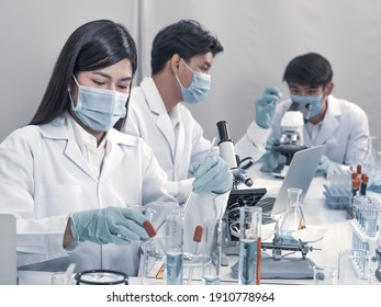 Asian Scientists Work In Hospital Pharmacology Science Research Lab. Woman Medical Scientist And Researchers Teamwork Analyzing Innovative Virus Protective Vaccines In Health Care Biology Laboratory