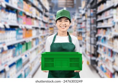 Asian seller wear green apron and green cap smiling in retail store - Powered by Shutterstock