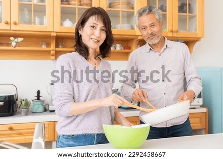 asian senior age couple who cooks