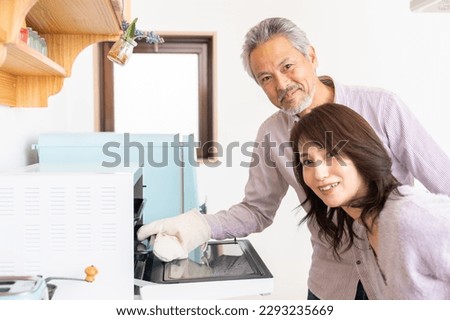 asian senior age couple who cooks,oven 