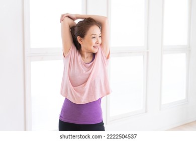 Asian senior age woman exercising in the room - Shutterstock ID 2222504537