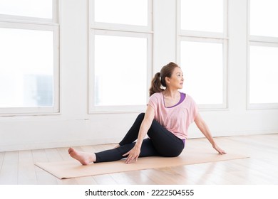 Asian senior age woman exercising in the room