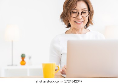 Asian Senior Age Woman Using Laptop